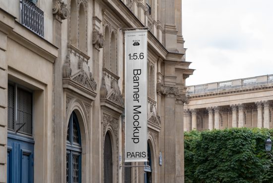 Urban street banner mockup hanging on classic Paris building, perfect for designing outdoor advertising graphics in urban settings.